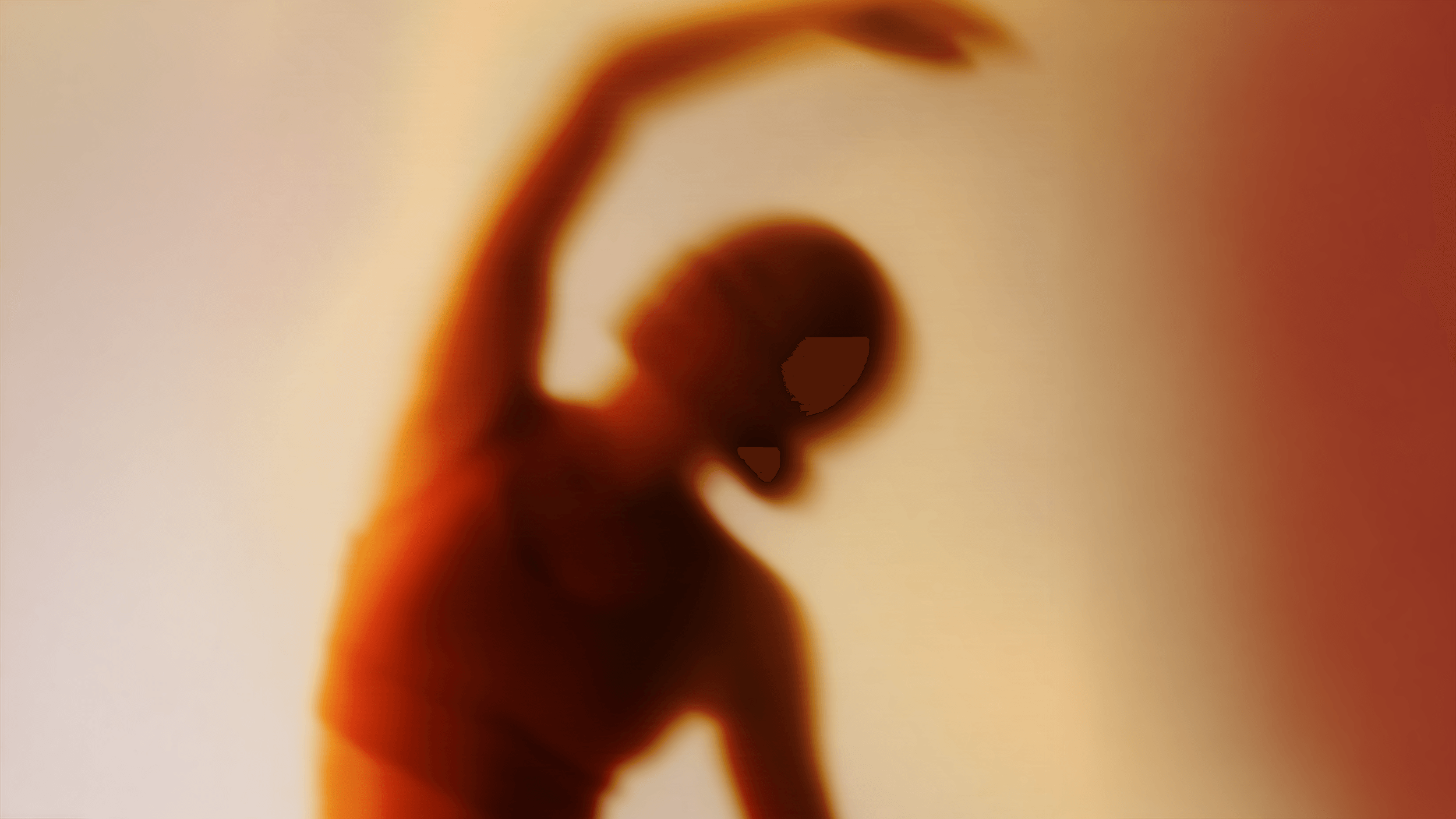 Blurred silhouette of a person in an orange top stretching with one arm raised.